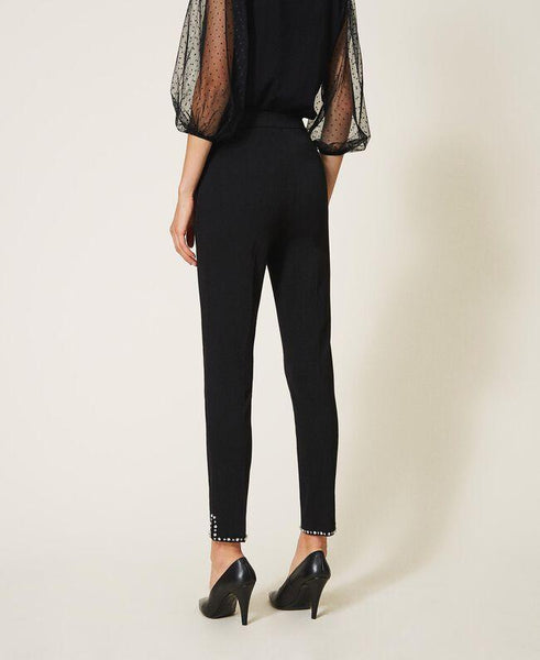 Pantaloni a sigaretta con borchie