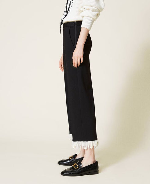 Pantaloni cropped con frange